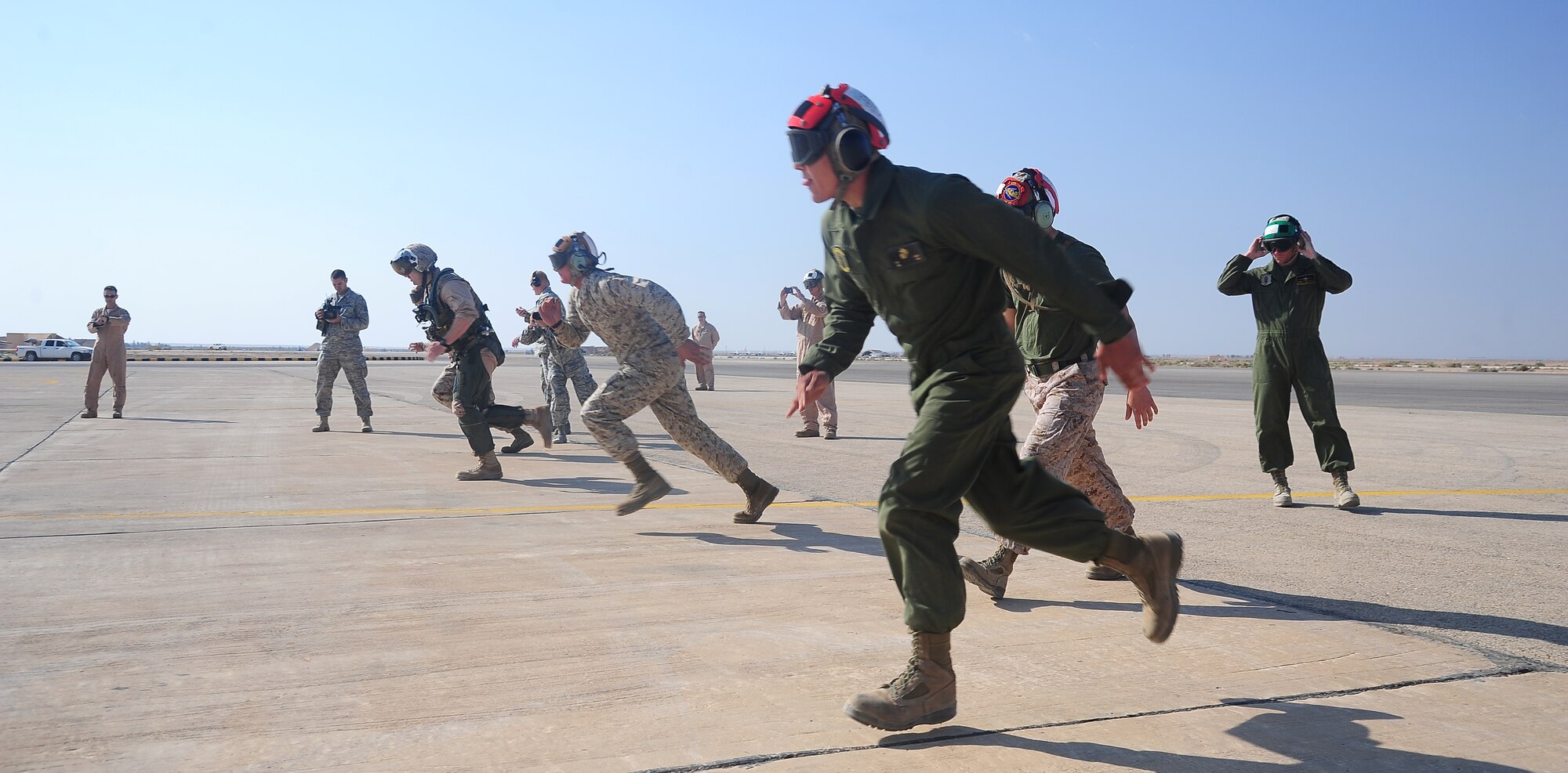 Members assigned to Marine Air Group 50 at Marine Corps Air Station Miramar, Calif., sprint toward their F-18 Hornet during a scramble competition at Exercise Eager Tiger May 12, 2014, at an air base in northern Jordan. The Marines competed against crews from the U.S. Air Force and Royal Jordanian Air Force to see who could fastest prepare their aircraft for takeoff. (U.S. Air Force photo by Staff Sgt. Brigitte N. Brantley/Released)