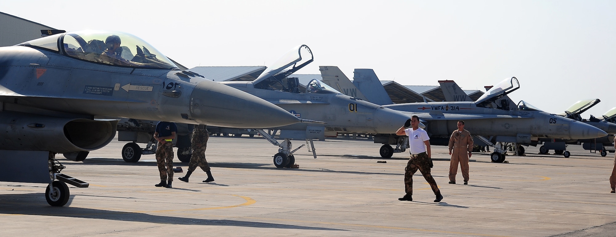 Members of the Royal Jordanian Air Force rush to launch an F-16 Fighting Falcon during a scramble competition at Exercise Eager Tiger May 12, 2014, at an air base in northern Jordan. They competed against crews from the U.S. Air Force and U.S. Marine Corps to see who could fastest prepare their aircraft for takeoff. (U.S. Air Force photo by Staff Sgt. Brigitte N. Brantley/Released)