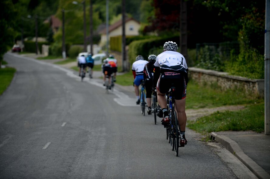 Cyclists ride through a village along the route to Paris, May 9, 2014. The bicycle route to Paris was three days long and approximately 290 miles. (U.S. Air Force photo by Airman 1st Class Kyle Gese/Released)