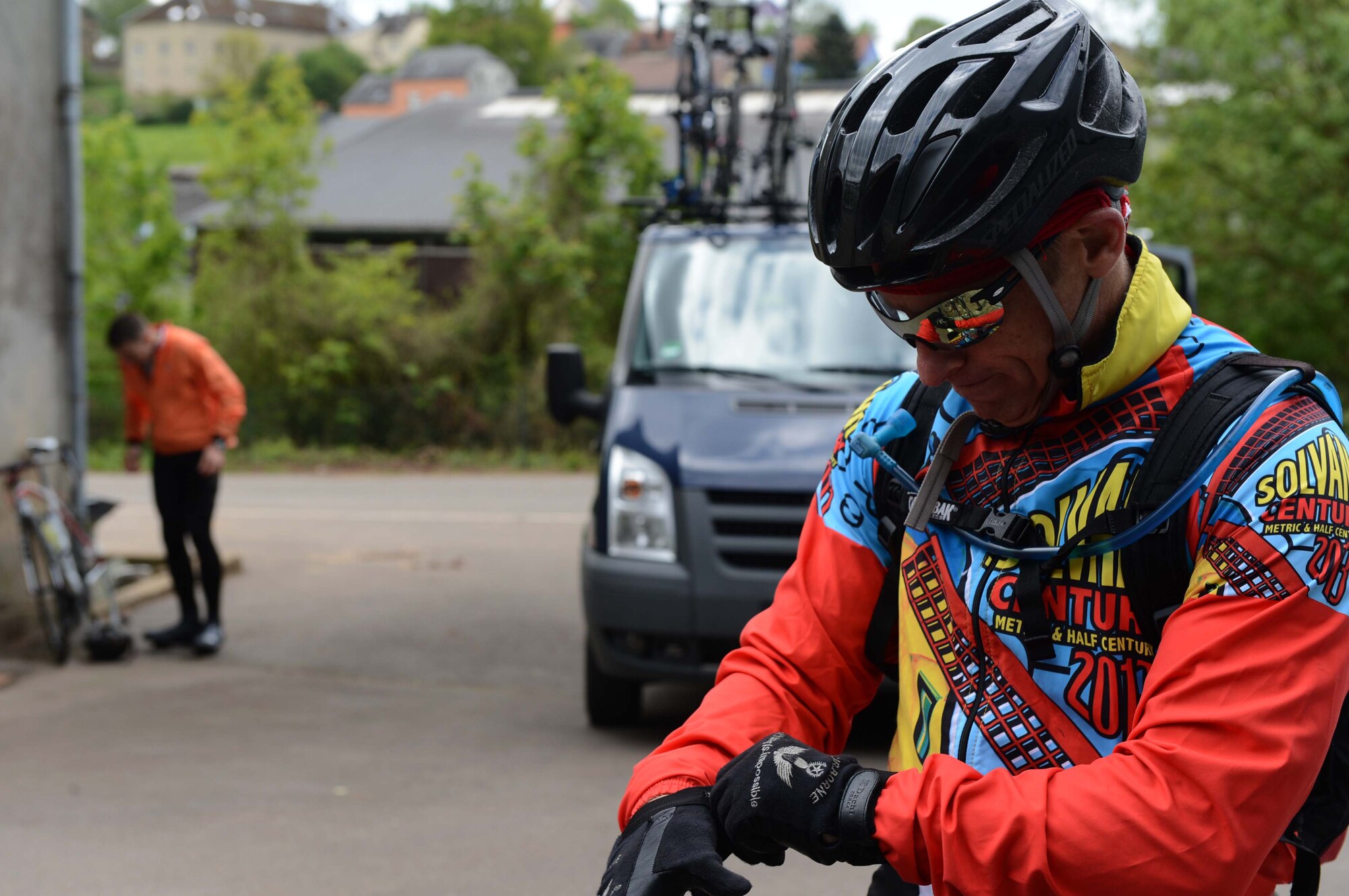 U.S. Air Force Lt. Col. Daniel Murray, 52nd Aerospace Medicine Squadron commander, puts his gloves on before leaving a rest stop on the way to Paris, May 8, 2014. A support team provided food, water and emergency services for the riders who participated in the Eifel-to-Eiffel bicycle ride. (U.S. Air Force photo by Airman 1st Class Kyle Gese/Released)