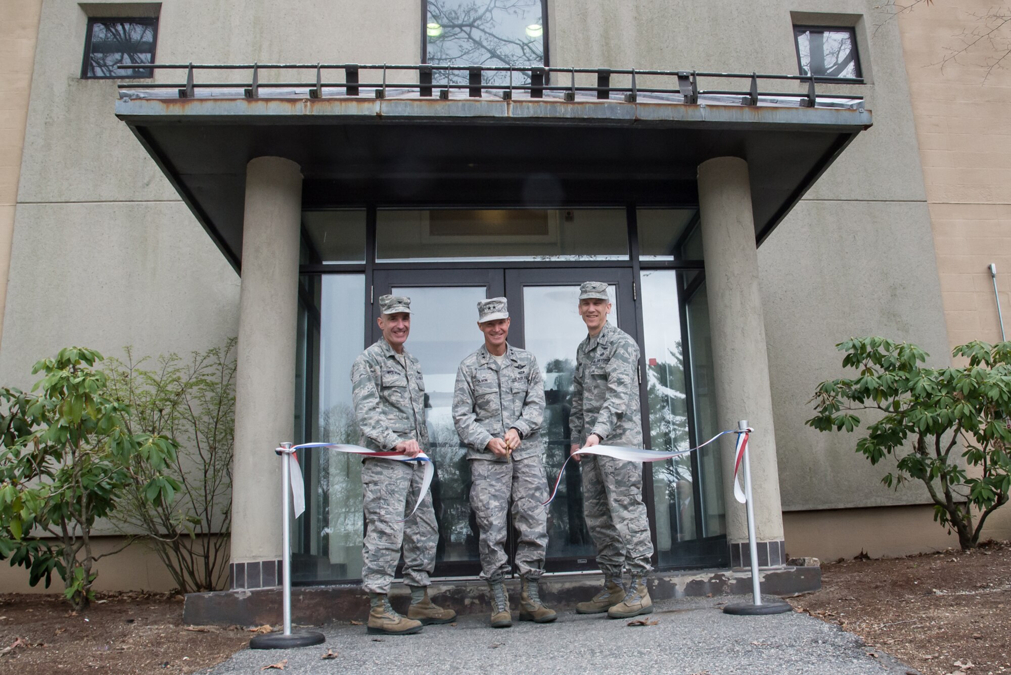 U.S. Air Force Maj. Gen. Craig Olson, C3I&N program executive officer, center, and Cols. Lester A. Weilacher, 66th Air Base Group commander, left, and Bill Polakowski, C3I Infrastructure Division senior materiel leader, cut the ribbon and open the doors to a new cyber security facility on Hanscom Air Force Base, Mass., May 6. The new Intranet Control Weapons System Gateway Integration Facility provides the Air Force an environment to conduct cyber security testing and integration at a reduced cost. (U.S. Air Force photo by Walter Santos)
