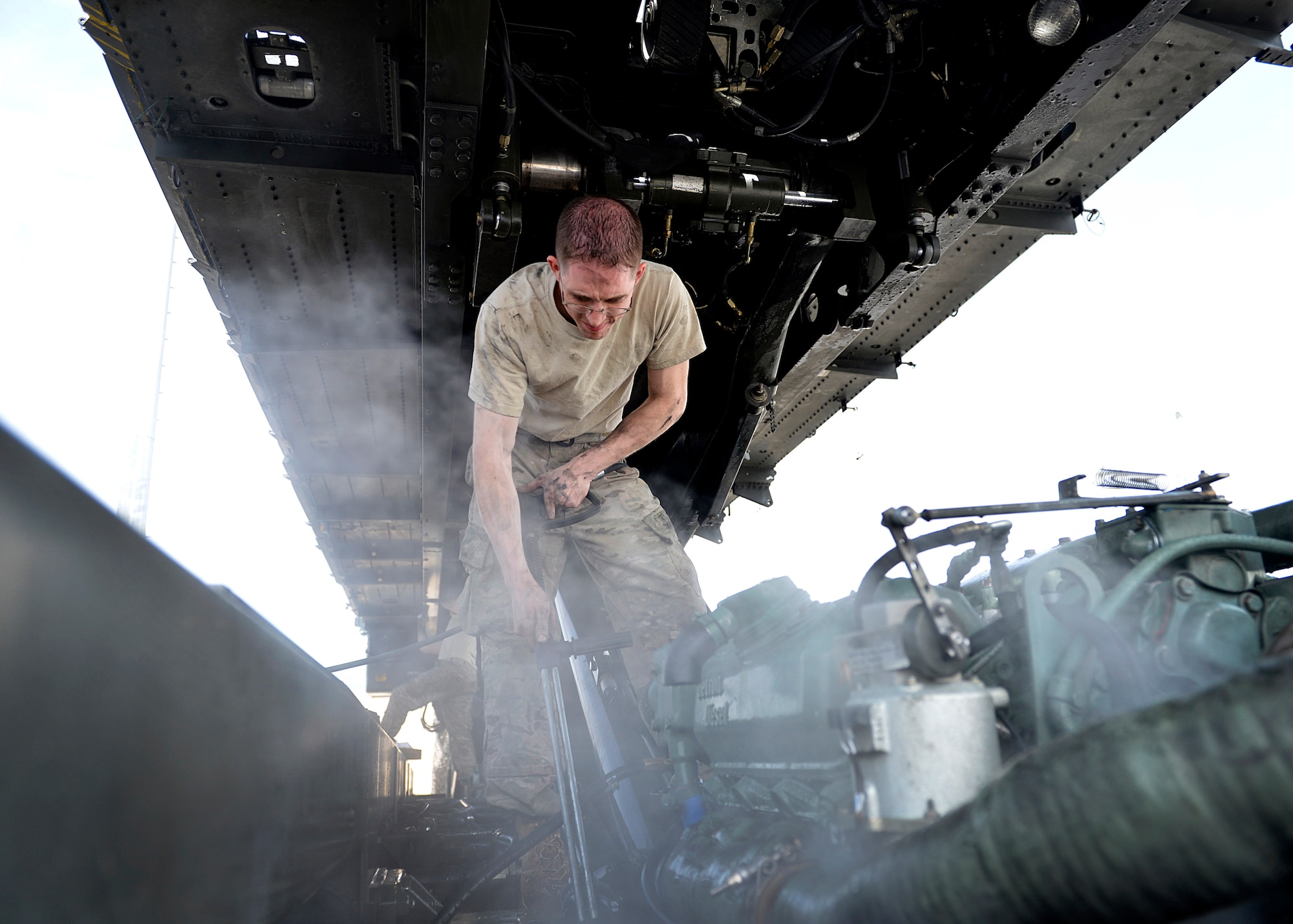 Staff Sgt. Ryan Schmitz 455th Expeditionary Logistics Readiness Squadron vechicle maintenance journeyman sprays off a truck with water before a vehicle inspection May 7, 2014 at Bagram Airfield, Afghanistan.  As a vehicle maintainer at here, Schmitz helps ensure more than 350 vehicles are operational and ready for their daily mission.  Schmitz is deployed from Yokota Air Base, Japan and a native of Kimball, Minn. (U.S. Air Force photo by Staff Sgt. Evelyn Chavez/Released) 