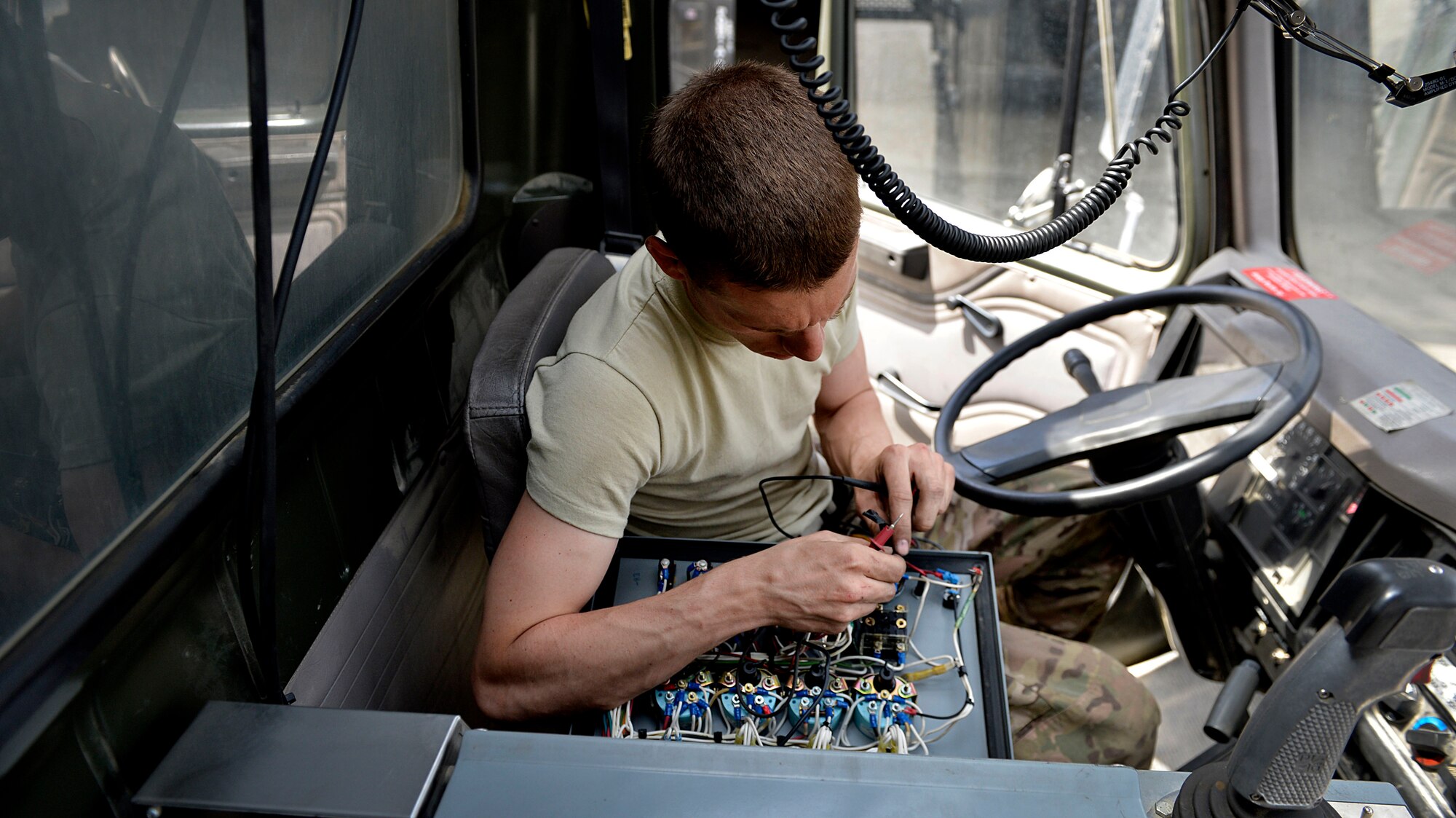 Staff Sgt. Cody McDonald, 455th Expeditionary Logistics Readiness Squadron vehicle maintenance journeyman, fixes electrical wires on a truck May 7, 2014 at Bagram Airfield, Afghanistan.  As a vehicle maintainer, McDonald is trained to repair, inspect and maintain vehicles that are essential to the daily mission.  McDonald is deployed from Joint Base Elmendorf-Richardson, Ala. and a native of Chesterfield, Mich.  (U.S. Air Force photo by Staff Sgt. Evelyn Chavez/Released)
