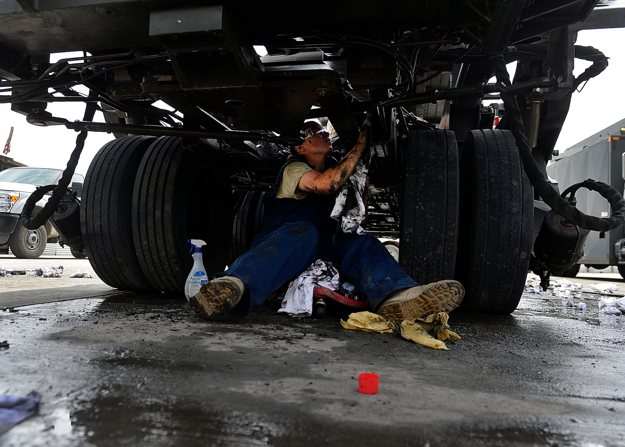 Staff Sgt. Alyssa Sutton, 455th Expeditionary Logistics Readiness Squadron vehicle maintenance material handling equipment mechanic, wipes grease off a truck May 7, 2014 at Bagram Airfield, Afghanistan.  As a vehicle maintainer, Sutton is trained to repair, inspect and maintain vehicles that are essential to the daily mission.  Sutton is deployed from Altus Air Force Base, Okla. and a native of Hudson S.D.  (U.S. Air Force photo by Staff Sgt. Evelyn Chavez/Released)