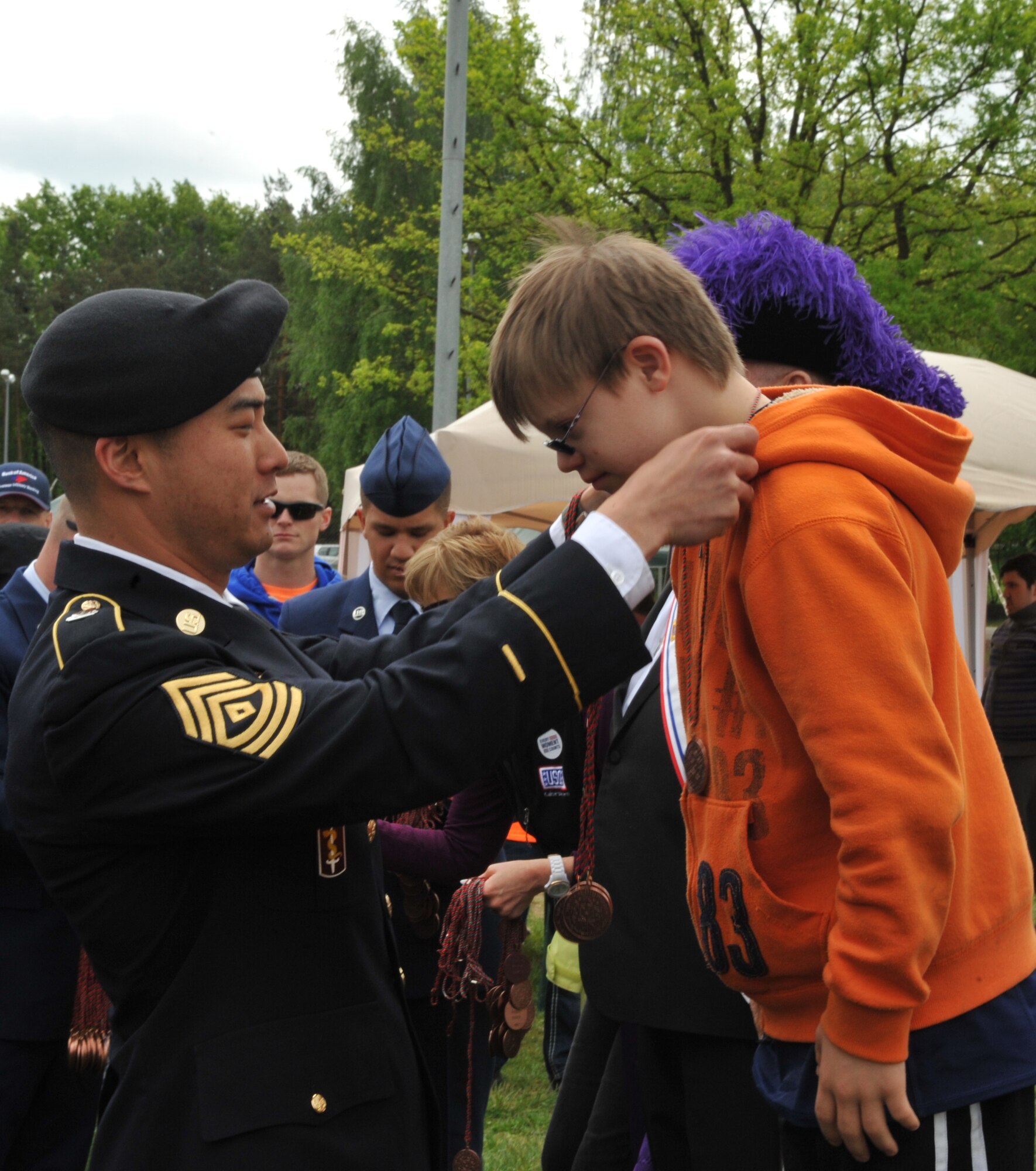 James Lucas, son of Master Sgt. Leilani Lucas, gets a medal at the end of the day’s events during the 2014 Spring Special Olympics began in Pulaski Park, May 9, 2014. This year’s Special Olympics consisted of events such as track and field, soccer, volleyball, basketball, softball, arts and crafts and karaoke; there were also non-competitive events for children ages five to seven who weren’t able compete yet according to the rules. (U.S. Air Force photo/Senior Airman Hailey Haux)