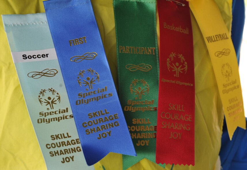 A set of ribbons is displayed on the shirt of an athlete during the 2014 Spring Special Olympics began in Pulaski Park, May 9, 2014. This year’s Special Olympics consisted of events such as track and field, soccer, volleyball, basketball, softball, arts and crafts and karaoke; there were also non-competitive events for children ages five to seven who weren’t able compete yet according to the rules. (U.S. Air Force photo/Senior Airman Hailey Haux)
