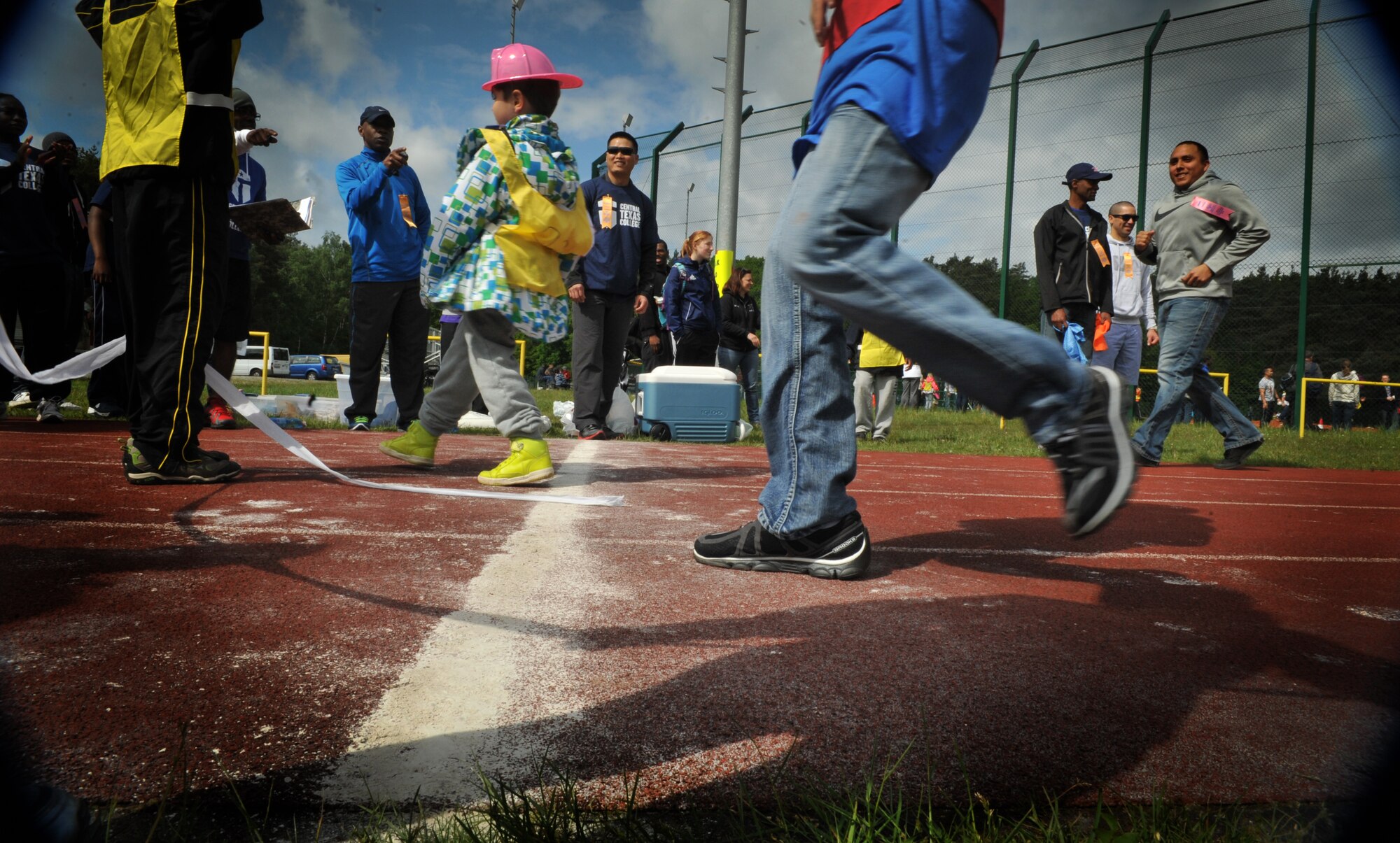 Athletes runs through the finish line during the 2014 Spring Special Olympics began in Pulaski Park, May 9, 2014. This year’s Special Olympics consisted of events such as track and field, soccer, volleyball, basketball, softball, arts and crafts and karaoke; there were also non-competitive events for children ages five to seven who weren’t able compete yet according to the rules. (U.S. Air Force photo/Senior Airman Hailey Haux)