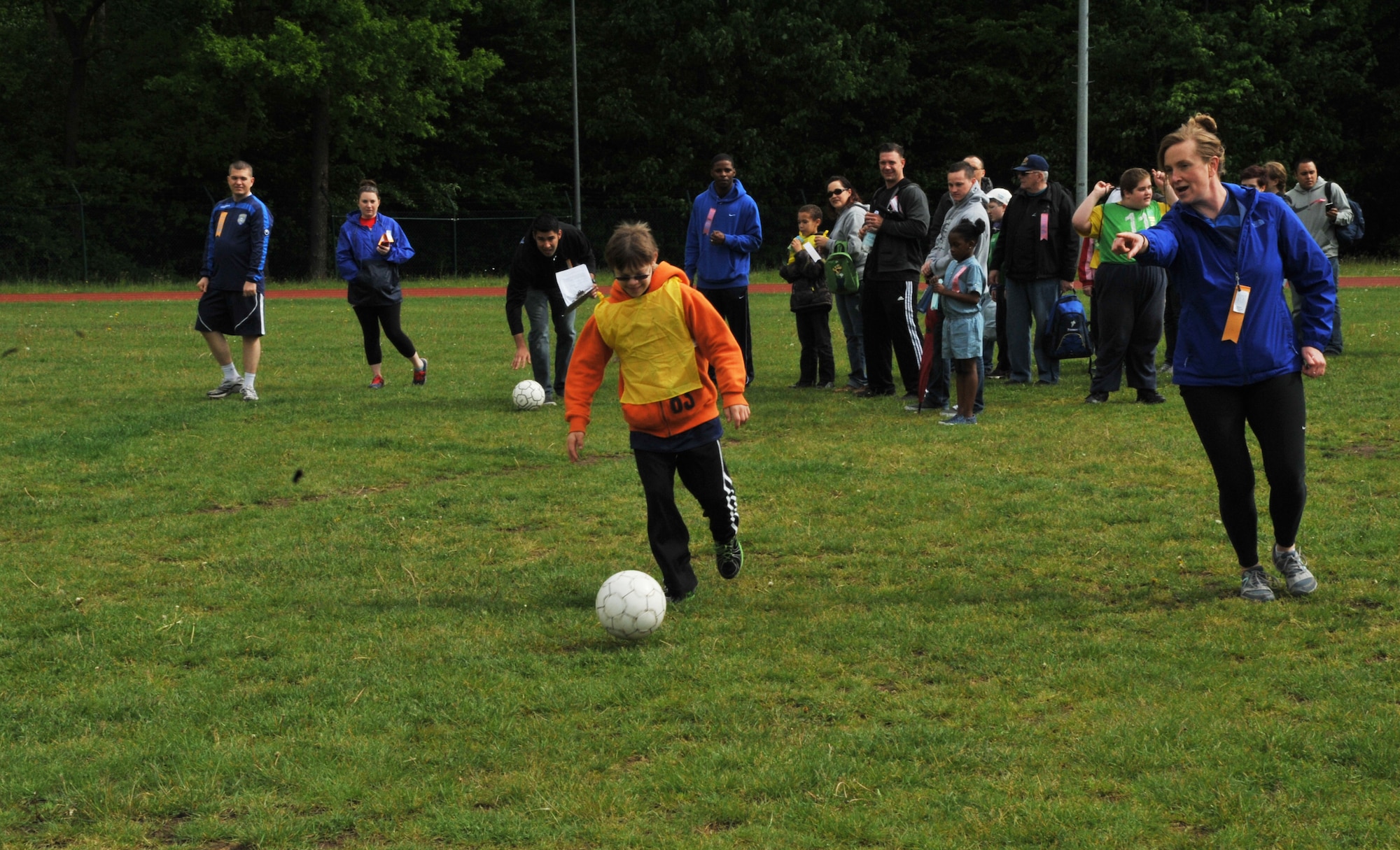 James Lucas, son of Master Sgt. Leilani Lucas, plays soccer during the 2014 Spring Special Olympics began in Pulaski Park, May 9, 2014. This year’s Special Olympics consisted of events such as track and field, soccer, volleyball, basketball, softball, arts and crafts and karaoke; there were also non-competitive events for children ages five to seven who weren’t able compete yet according to the rules. (U.S. Air Force photo/Senior Airman Hailey Haux)