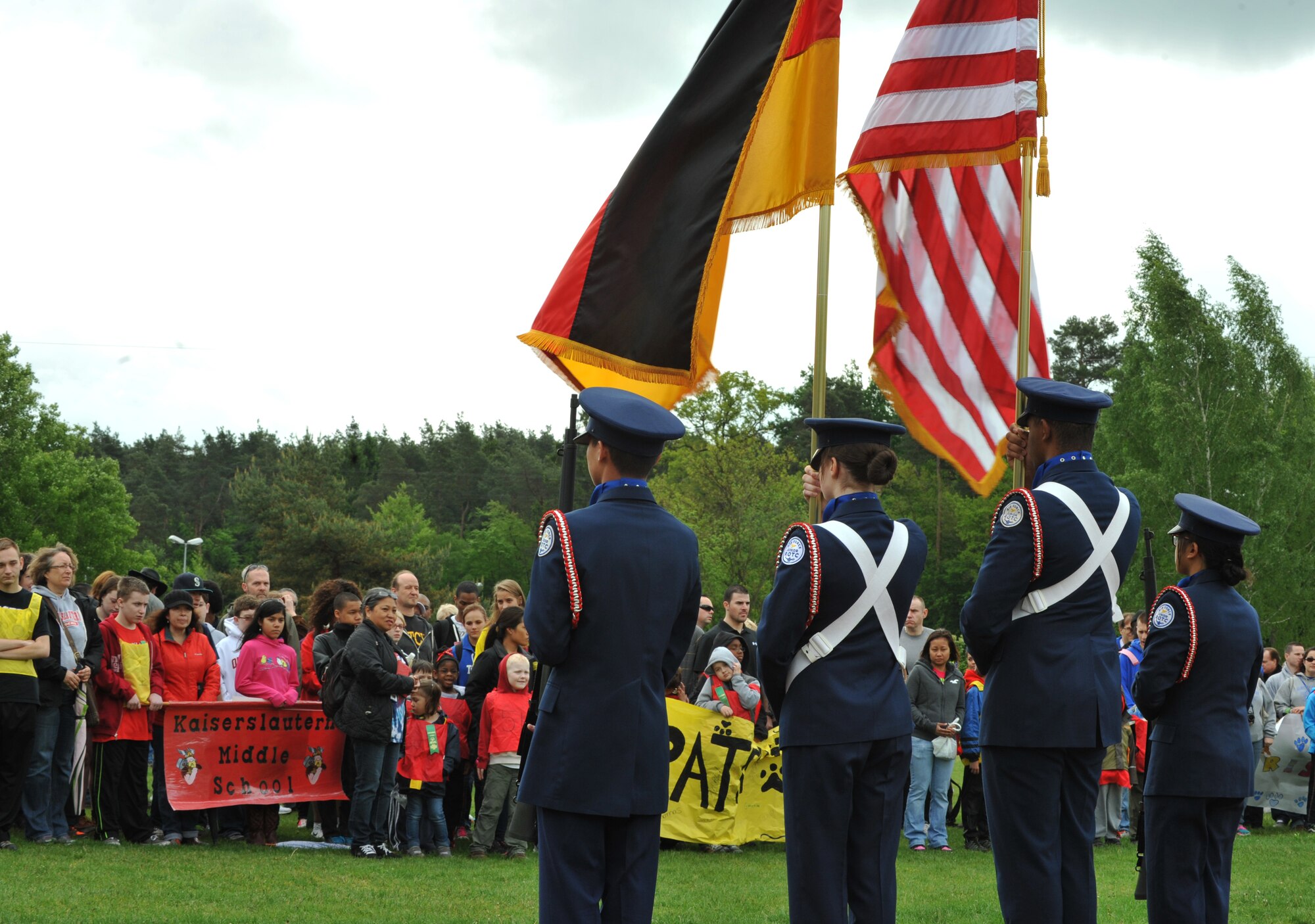 Athletes, volunteers and their families stand silent as the German and American national anthems are sung before the 2014 Spring Special Olympics began in Pulaski Park, May 9, 2014. This year’s Special Olympics consisted of events such as track and field, soccer, volleyball, basketball, softball, arts and crafts and karaoke; there were also non-competitive events for children ages five to seven who weren’t able compete yet according to the rules. (U.S. Air Force photo/Senior Airman Hailey Haux)
