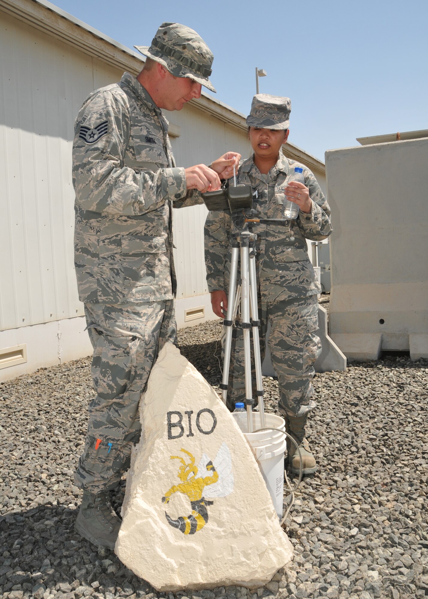 Air Force Staff Sergeants Jonathan Smith and Sarah-Jane Mesina, 380th Expeditionary Medical Group bioenvironmental engineering technicians, check the wet bulb temperature at an undisclosed location in Southwest Asia May 7, 2014.  (U.S. Air Force photo by Senior Master Sgt. Eric Peterson/Released)