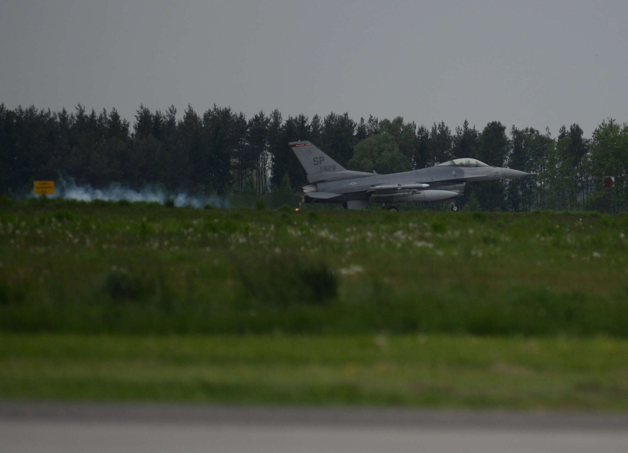 An F-16 Fighting Falcon fighter aircraft pilot lands an aircraft on the flightline at Łask Air Base, Poland, May 7, 2014. The U.S. Air Force and Polish air force maintain close ties with respect to training and partnership defense as part of the NATO alliance. (U.S. Air Force photo by Staff Sgt. Joe W. McFadden/Released)