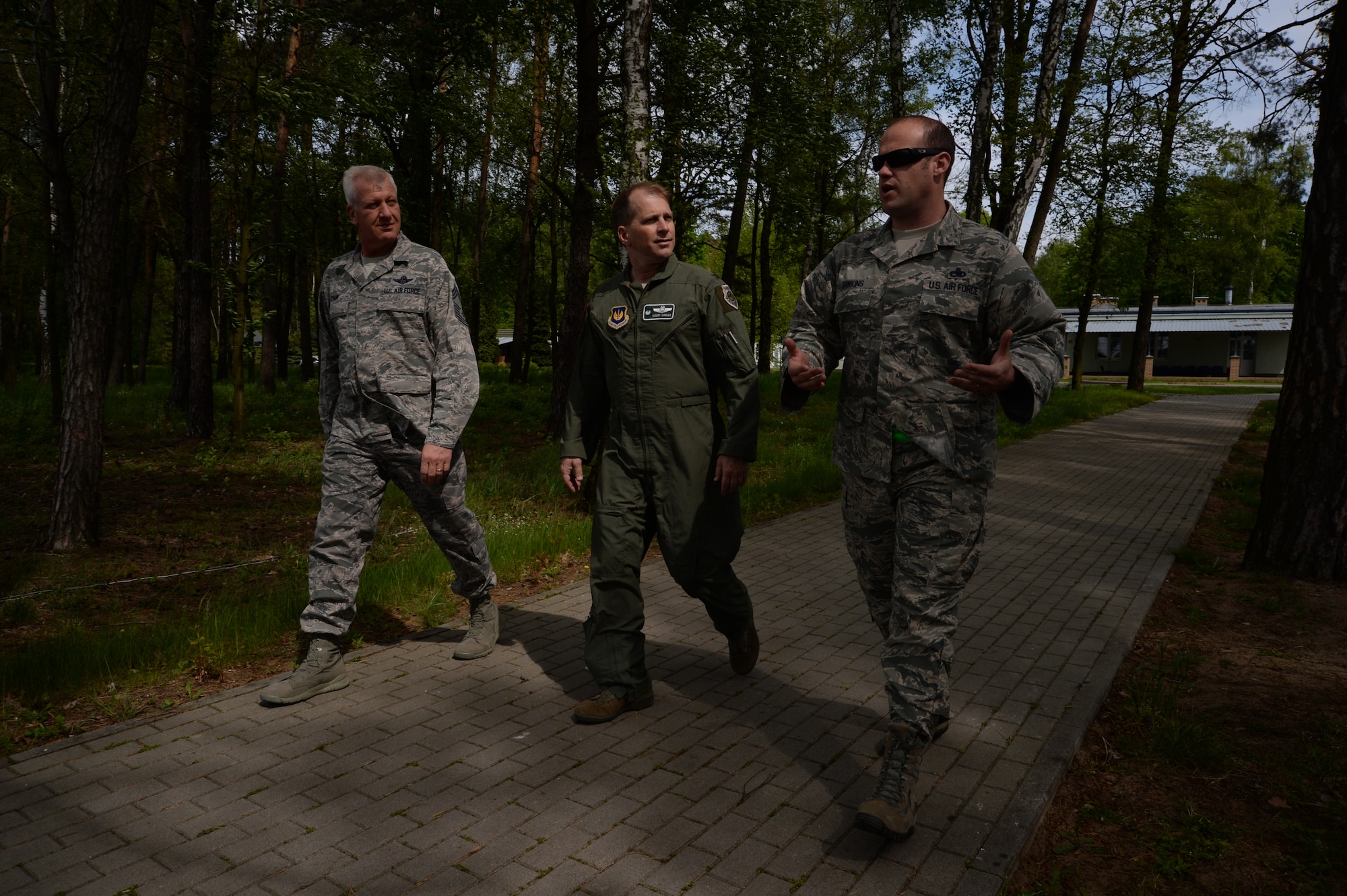 U.S. Air Force Col. Robert Winkler, 52nd Operations Group commander, center, and Chief Master Sgt. Bruce Zahn, 52nd OG chief enlisted manager, left, listen as Master Sgt. Mark Dawkins, Detachment 1, 52nd Operations Group maintenance operations liaison, right, discusses maintenance operations while walking to the flightline at Łask Air Base, Poland, May 7, 2014. Dawkins serves with nine other personnel assigned to Detachment 1, which aims to strengthen interoperability between the U.S. and Polish air forces.   (U.S. Air Force photo by Staff Sgt. Joe W. McFadden/Released)
