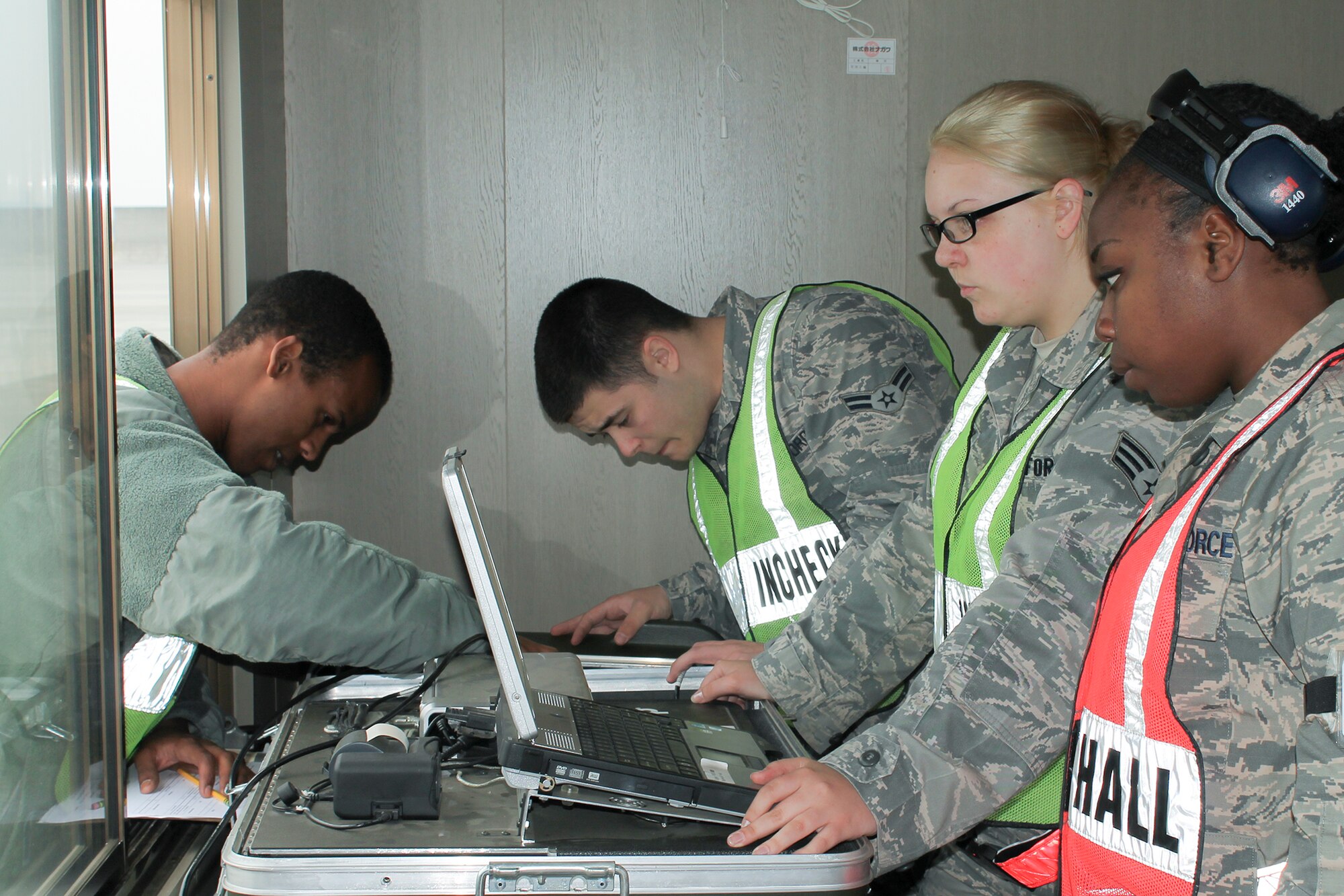 Airmen from the 374th Logistics Readiness Squadron as well as augmentees, calibrate scales during the Samurai Readiness Inspection at Yokota Air Base, Japan, May 13, 2014. Yokota Airmen participated in a week-long Samurai Readiness Inspection that tested their capability to respond to humanitarian aid and disaster relief contingencies in the Pacific region. (U.S. Air Force photo by Airman 1st Class David Danford/Released)