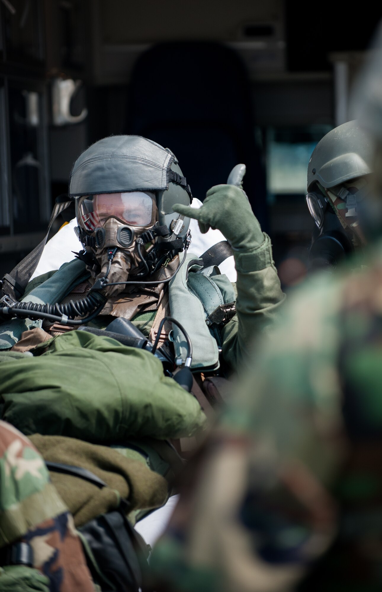Victor Ditommaso, 35th Fighter Squadron, gives a "push it up" sign while being evacuated from the flight line during exercise Beverly Bulldog 14-2 at Kunsan Air Base, Republic of Korea, May 9, 2014. This exercise tested the Wolf Pack's ability to perform its mission while under threat of chemical attack. (U.S. Air Force photo by Staff Sgt. Clayton Lenhardt/Released)