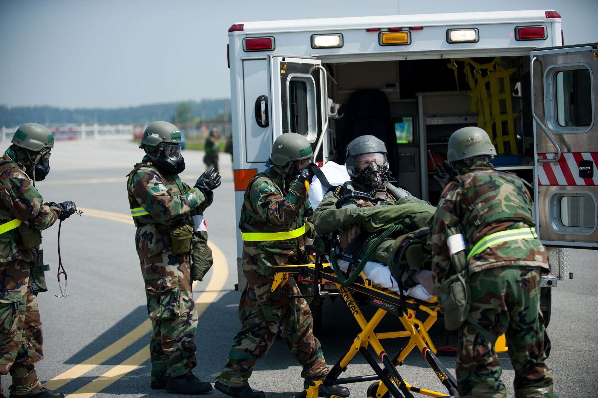 Airmen from the 8th Medical Group transport a simulated contaminated pilot during exercise Beverly Bulldog 14-2 at Kunsan Air Base, Republic of Korea, May 9, 2014. This exercise tested the Wolf Pack's ability to perform its mission while under threat of chemical attack. (U.S. Air Force photo by Staff Sgt. Clayton Lenhardt/Released)