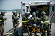 Airmen from the 8th Medical Group transport a simulated contaminated pilot during exercise Beverly Bulldog 14-2 at Kunsan Air Base, Republic of Korea, May 9, 2014. This exercise tested the Wolf Pack's ability to perform its mission while under threat of chemical attack. (U.S. Air Force photo by Staff Sgt. Clayton Lenhardt/Released)