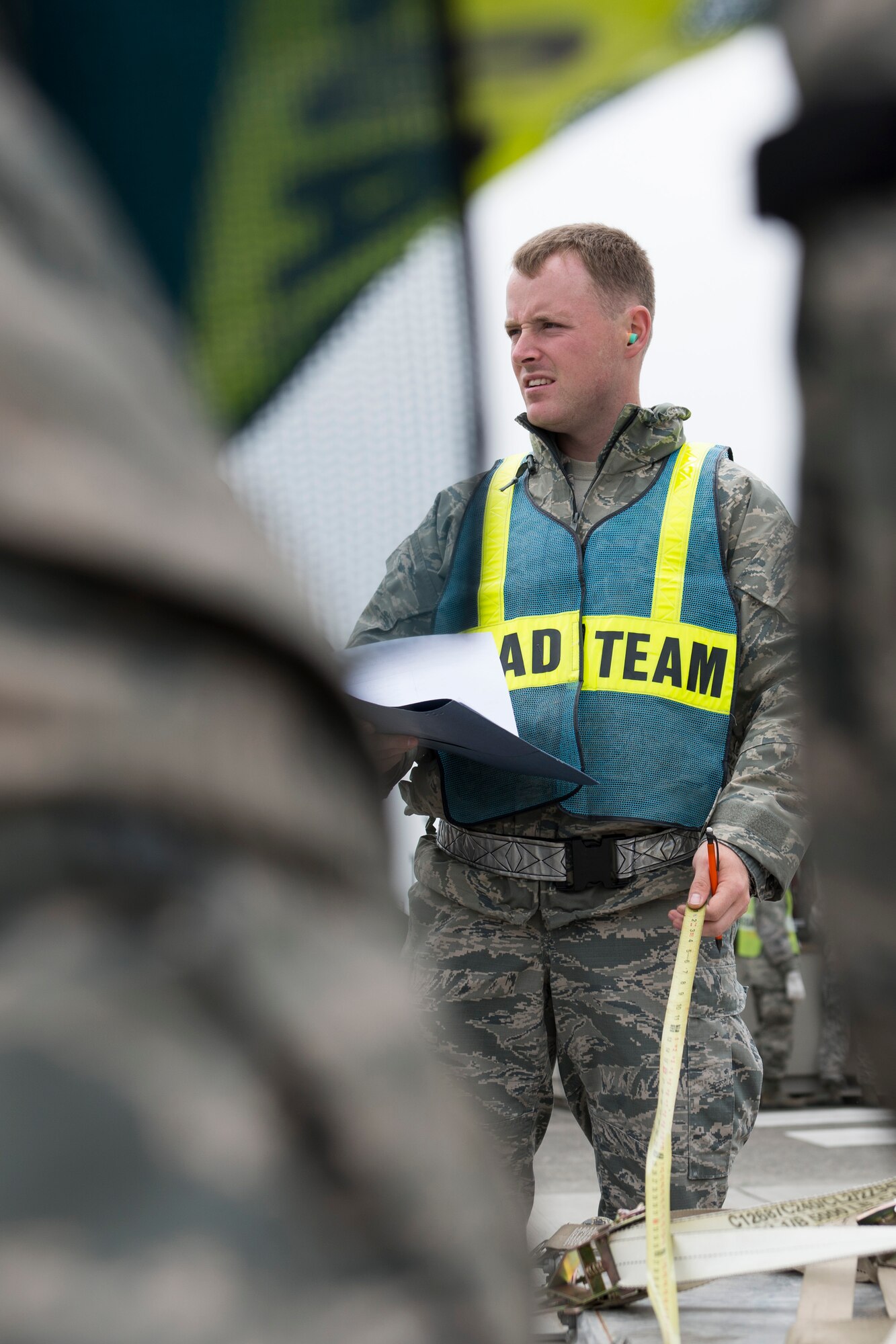 An augmentee measures the length of a cargo pallet during a Samurai Readiness Inspection at Yokota Air Base, Japan, May 13, 2014. Units throughout Yokota provided trained augmentees to assist with cargo planning, movements and loading, ensuring Yokota had the manning needed when called upon to provide humanitarian aid and disaster relief in the Pacific region. (U.S. Air Force photo by Staff Sgt. Cody H. Ramirez/Released)