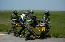 Airmen from the 8th Medical Group transport a simulated contaminated pilot during exercise Beverly Bulldog 14-2 at Kunsan Air Base, Republic of Korea, May 9, 2014. This exercise tested the Wolf Pack's ability to perform its mission while under threat of chemical attack. (U.S. Air Force photo by Staff Sgt. Clayton Lenhardt/Released)