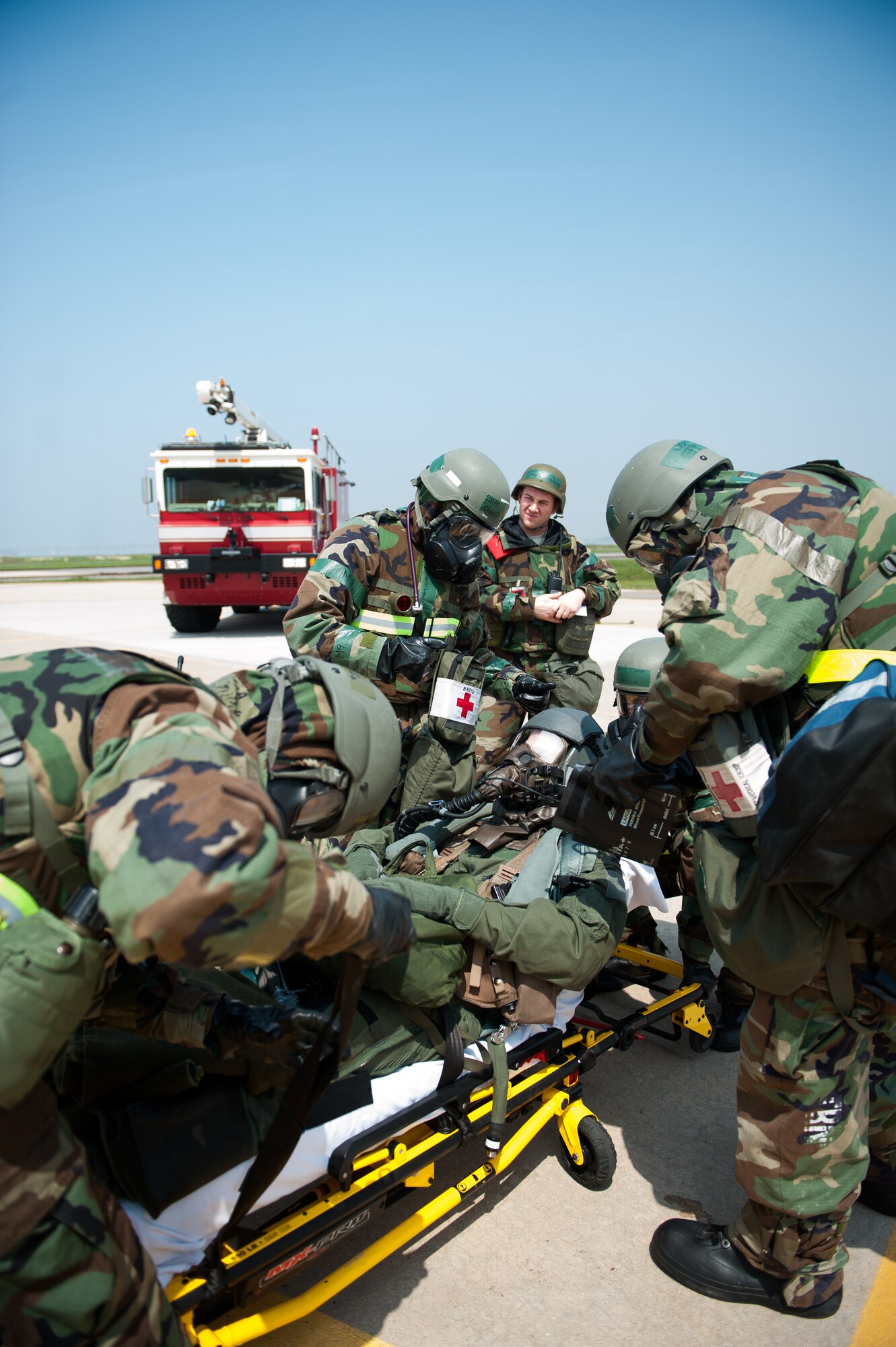Airmen from the 8th Medical Group transport a simulated contaminated pilot during exercise Beverly Bulldog 14-2 at Kunsan Air Base, Republic of Korea, May 9, 2014. This exercise tested the Wolf Pack's ability to perform its mission while under threat of chemical attack. (U.S. Air Force photo by Staff Sgt. Clayton Lenhardt/Released)