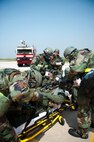 Airmen from the 8th Medical Group transport a simulated contaminated pilot during exercise Beverly Bulldog 14-2 at Kunsan Air Base, Republic of Korea, May 9, 2014. This exercise tested the Wolf Pack's ability to perform its mission while under threat of chemical attack. (U.S. Air Force photo by Staff Sgt. Clayton Lenhardt/Released)