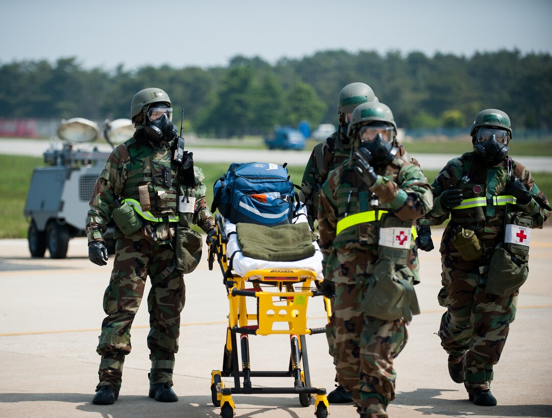 Airmen from the 8th Medical Group respond to a simulated contaminated pilot during exercise Beverly Bulldog 14-2 at Kunsan Air Base, Republic of Korea, May 9, 2014. This exercise tested the Wolf Pack's ability to perform its mission while under threat of chemical attack. (U.S. Air Force photo by Staff Sgt. Clayton Lenhardt/Released)