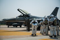 Airmen from the 8th Civil Engineer Squadron fire department respond to a simulated contaminated pilot during exercise Beverly Bulldog 14-2 at Kunsan Air Base, Republic of Korea, May 9, 2014. This exercise tested the Wolf Pack's ability to perform its mission while under threat of chemical attack. (U.S. Air Force photo by Staff Sgt. Clayton Lenhardt/Released)