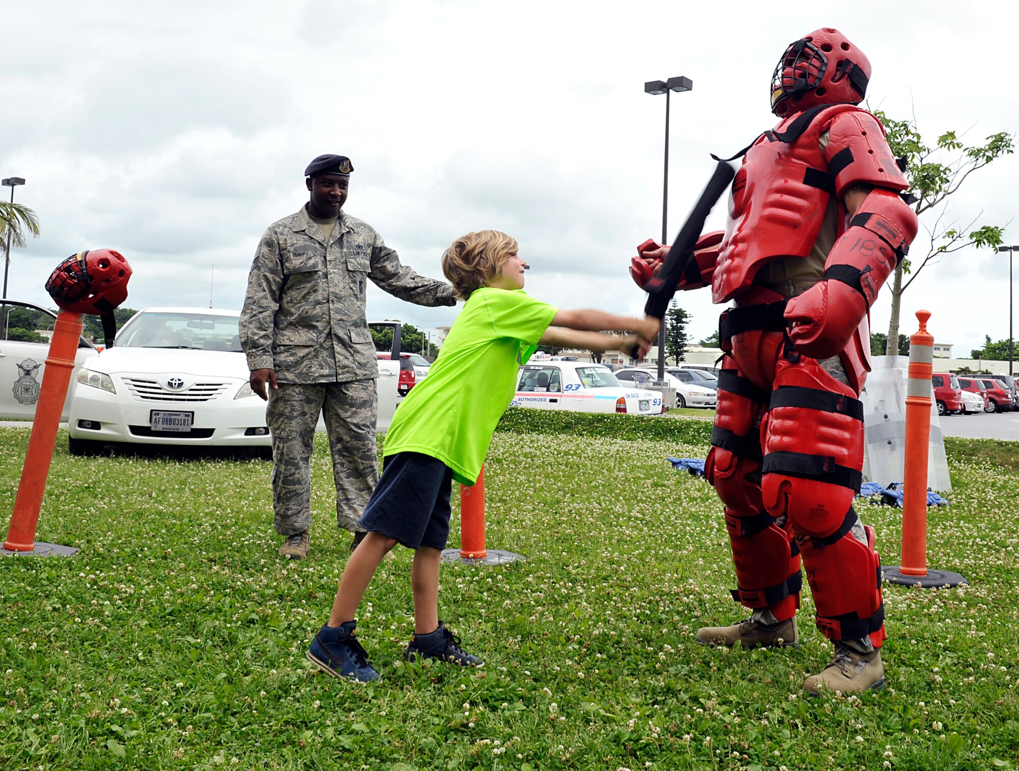 Harrison McMinimy attacks a REDMAN suit used in baton training during the Police Week open house on Kadena Air Base, Japan, May 12, 2014. National Police Week began in 1982, and has since brought thousands of survivors and law enforcement officers to Washington D.C. to celebrate Peace Officer Memorial Day every year. (U.S. Air Force photo by Naoto Anazawa)