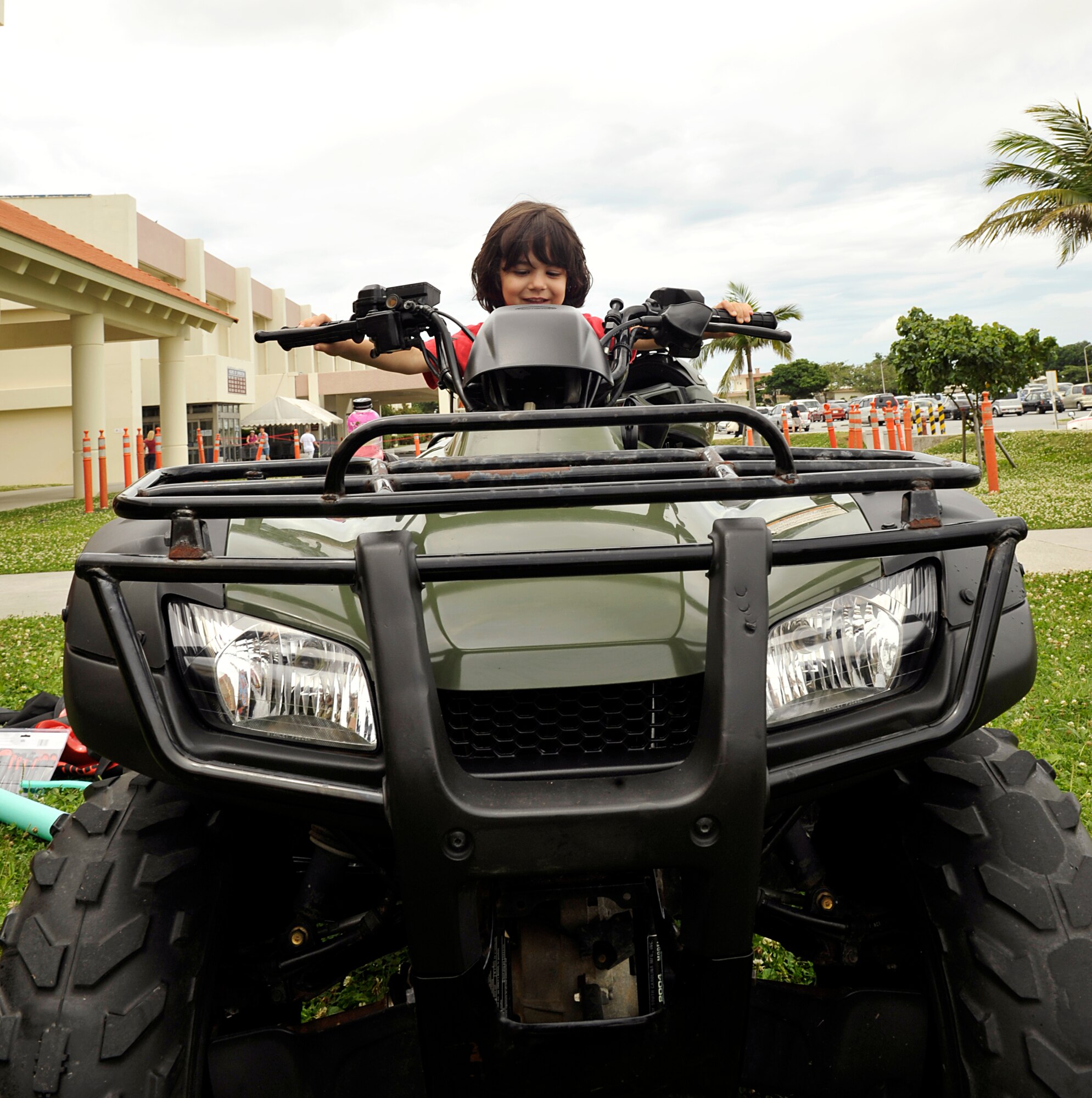 Micah Bose-Gomez sits on an all-terrain-vehicle during the Police Week open house on Kadena Air Base, Japan, May 12, 2014. The event was part of Team Kadena's observance of National Police Week, and allowed the public to experience vehicles and equipment used by security forces on a daily basis. (U.S. Air Force photo by Naoto Anazawa)