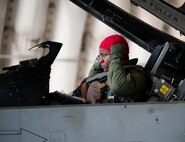 Lt. Col. Henry Jeffress, 80th Fighter Squadron director of operations, prepares for a flight during exercise Beverly Bulldog 14-2 at Kunsan Air Base, Republic of Korea, May 9, 2014. This exercise tested the Wolf Pack's ability to perform its mission while under threat of chemical attack. (U.S. Air Force photo by Staff Sgt. Clayton Lenhardt/Released)