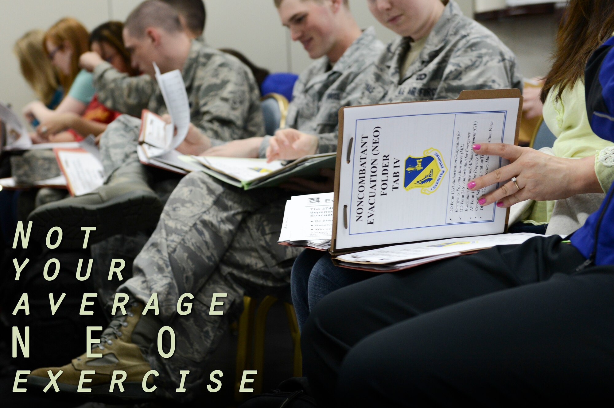 Airmen and families stationed at Yokota process through the Taiyo Community Center during a non-combatant evacuation exercise at Yokota Air Base, Japan, May 13, 2014.  As the Western Pacific Airlift Hub, Yokota maintains the capability to conduct short-notice evacuation operations. (U.S. Air Force graphic by Airman 1st Class Meagan Schutter/Released)