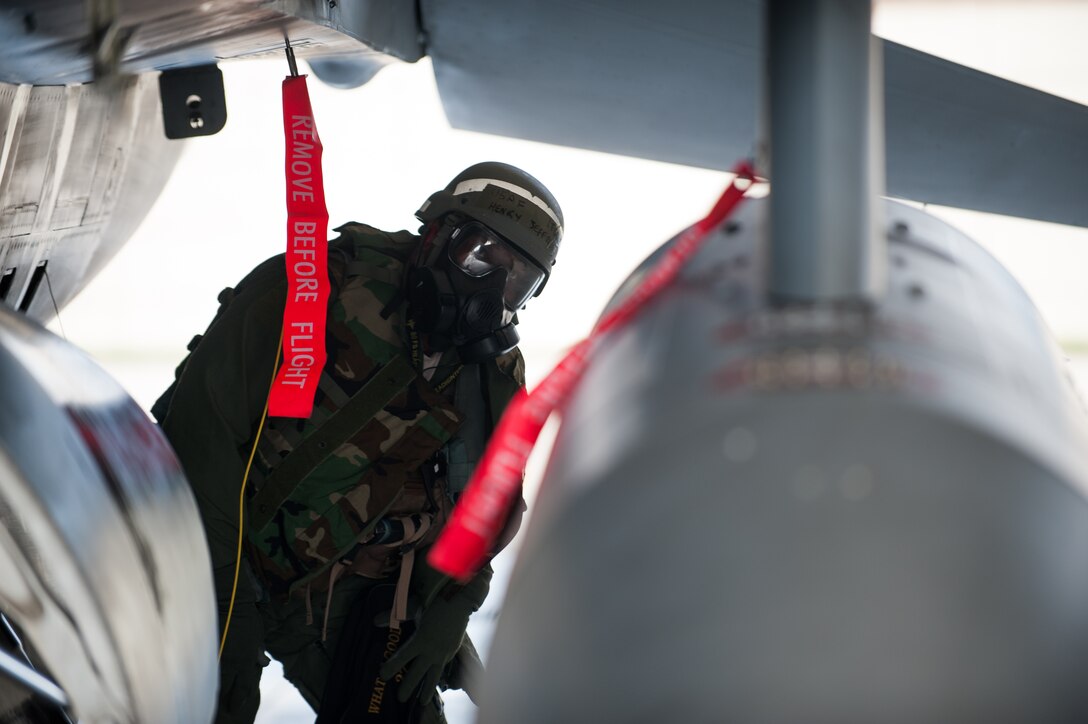 Lt. Col. Henry Jeffress, 80th Fighter Squadron director of operations, inspects an F-16 during exercise Beverly Bulldog 14-2 at Kunsan Air Base, Republic of Korea, May 9, 2014. This exercise tested the Wolf Pack's ability to perform its mission while under threat of chemical attack. (U.S. Air Force photo by Staff Sgt. Clayton Lenhardt/Released)