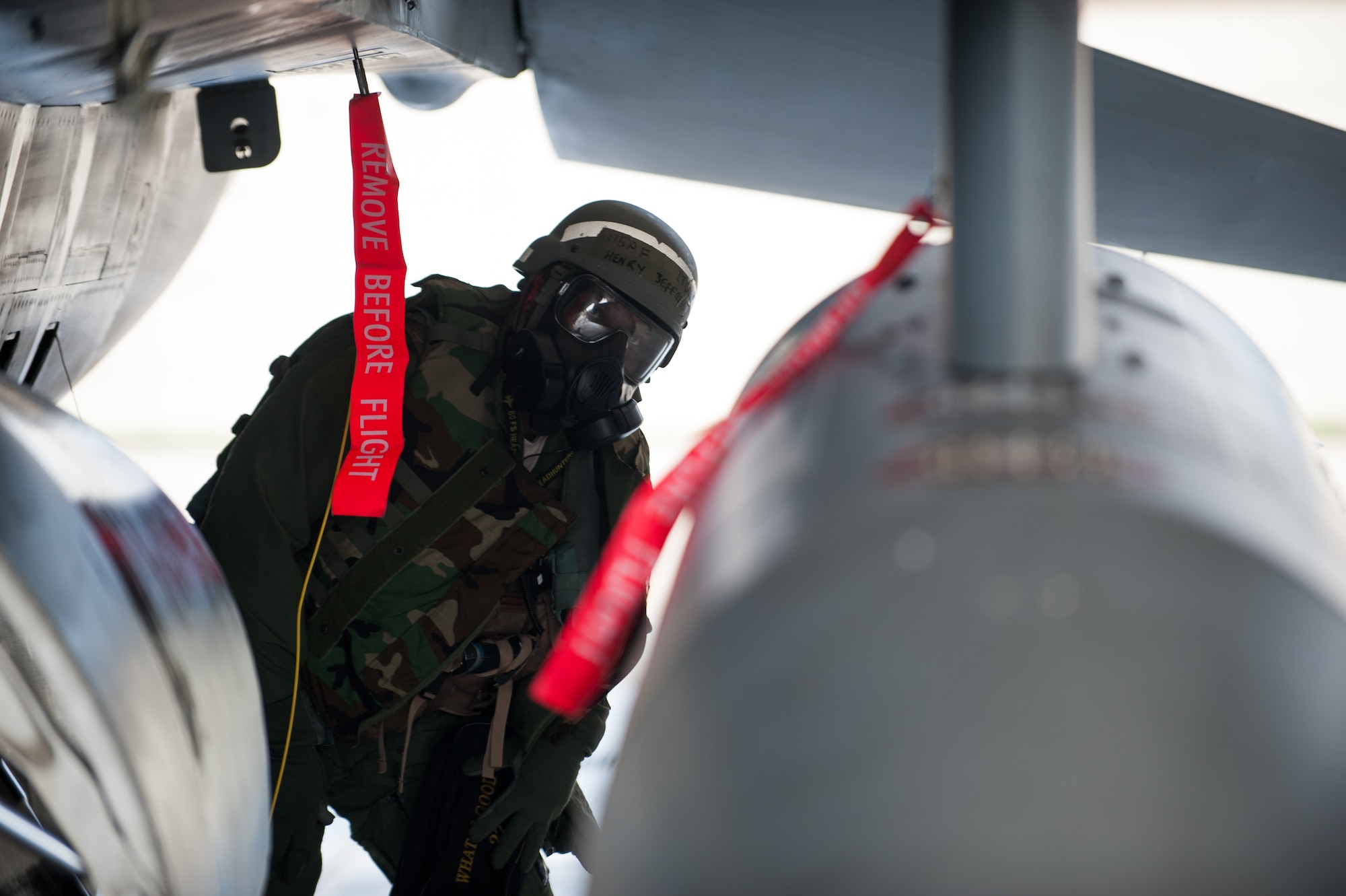 Lt. Col. Henry Jeffress, 80th Fighter Squadron director of operations, inspects an F-16 during exercise Beverly Bulldog 14-2 at Kunsan Air Base, Republic of Korea, May 9, 2014. This exercise tested the Wolf Pack's ability to perform its mission while under threat of chemical attack. (U.S. Air Force photo by Staff Sgt. Clayton Lenhardt/Released)