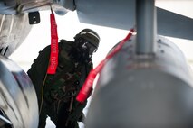 Lt. Col. Henry Jeffress, 80th Fighter Squadron director of operations, inspects an F-16 during exercise Beverly Bulldog 14-2 at Kunsan Air Base, Republic of Korea, May 9, 2014. This exercise tested the Wolf Pack's ability to perform its mission while under threat of chemical attack. (U.S. Air Force photo by Staff Sgt. Clayton Lenhardt/Released)