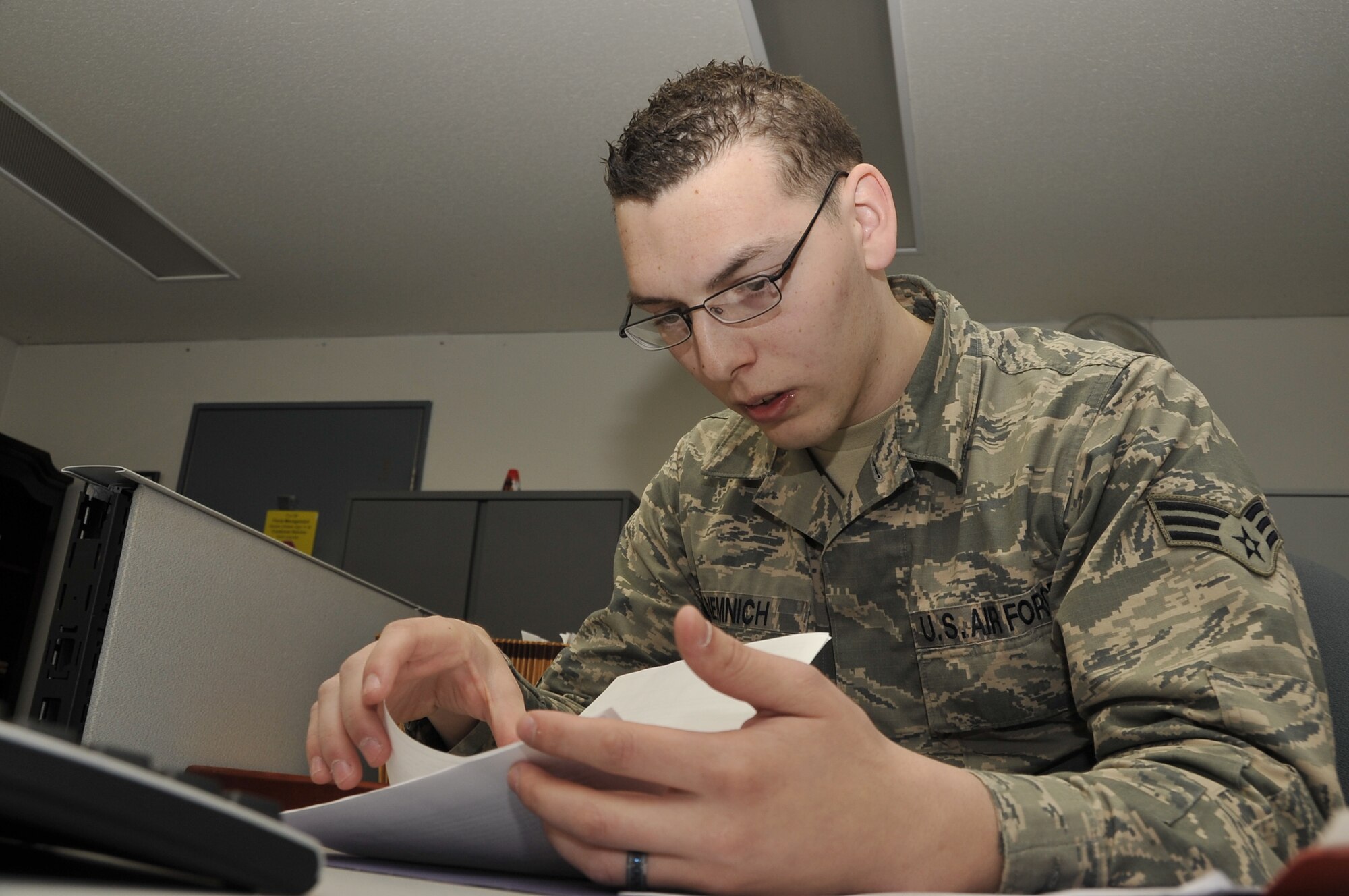 U.S. Air Force Senior Airman Steven Nemnich, 35th Force Support Squadron force management journeyman, reviews a service member’s awards and decorations paperwork at Misawa Air Base, Japan, April 29, 2014. The primary responsibilities of force management are ensuring that personnel records and decorations are kept up to date and providing guidance and policy to service members for special duty assignments. (U.S. Air Force photo/Airman 1st Class Patrick S. Ciccarone)