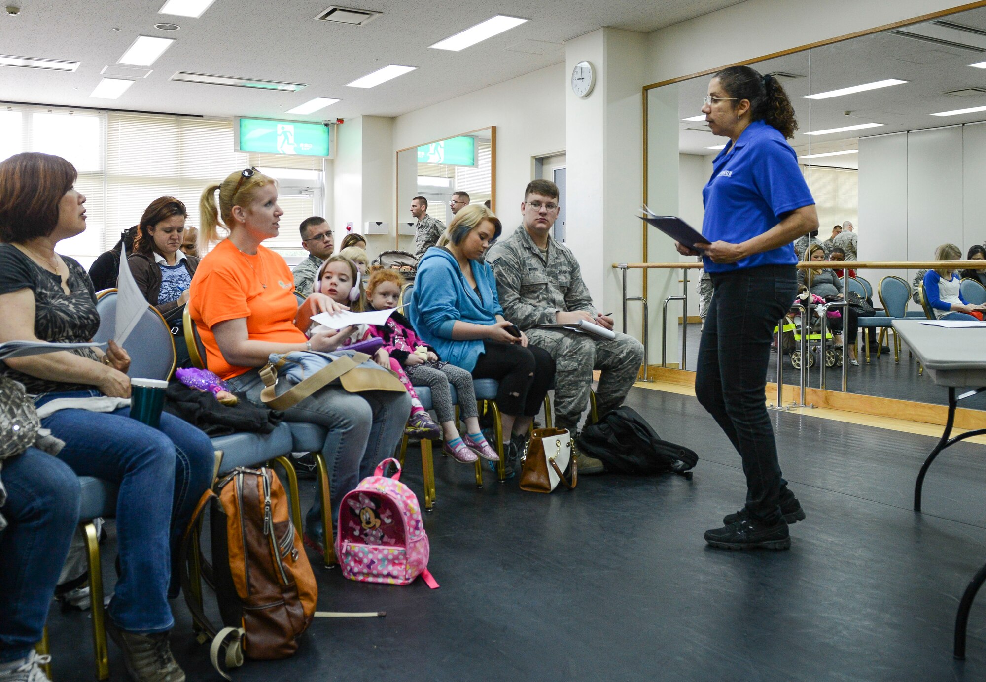 Nancy King, Airmen and Family Readiness work life consultant, answers a question during a briefing at the Taiyo Community Center during a non-combatant evacuation exercise at Yokota Air Base, Japan, May 13, 2014.  The exercise scenario gave Yokota family members the opportunity to learn about the evacuation process. (U.S. Air Force photo by Airman 1st Class Meagan Schutter/Released)