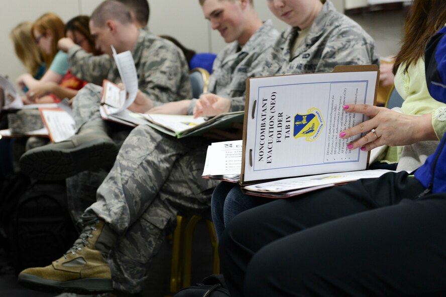 Airmen and families stationed at Yokota process through the Taiyo Community Center during a non-combatant evacuation exercise at Yokota Air Base, Japan, May 13, 2014.  As the Western Pacific Airlift Hub, Yokota maintains the capability to conduct short-notice evacuation operations. (U.S. Air Force photo by Airman 1st Class Meagan Schutter/Released)