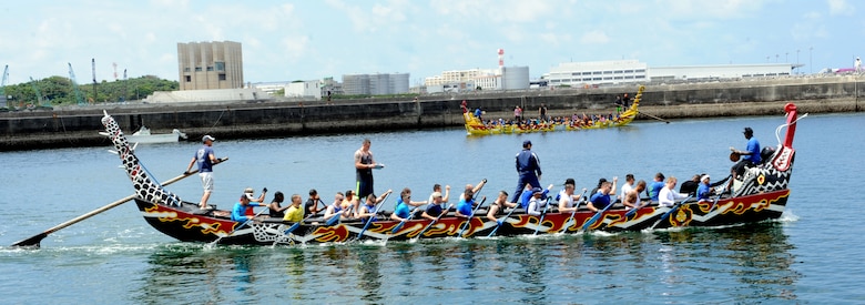 The Kadena men’s dragon boat team practices rowing in sync as the Kadena women’s dragon boat team passes in the distance in Naha City, Okinawa, Japan, April 12, 2014. The teams attended two dragon boat familiarization practices at the race location. (U.S. Air Force photo by Airman 1st Class Zade C. Vadnais)