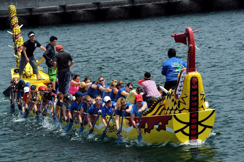 Members of the Kadena women’s dragon boat team learn to row their boat in unison during a practice session in Naha City, Okinawa, Japan, April 12, 2014. The team’s coach, Comica Middleton, bangs a metal drum at an even tempo to keep the team members in sync. (U.S. Air Force photo by Airman 1st Class Zade C. Vadnais)  