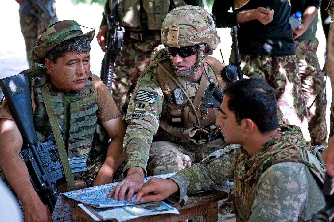 U.S. Army Capt. Nicholas Drake, center, talks with Afghan army Lt. Col. Mohammad Bashir, left, during a patrol break on the outskirts of Takiya Khana village in Bati Kot district in Afghanistan’s Nangarhar province, June 15, 2013. Drake is commander of the 101st Airborne Division's Security Forces Advisory and Assistance Team Archangel, 1st Battalion, 327th Infantry Regiment, 1st Brigade Combat Team. 