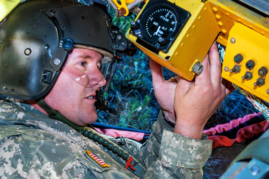 Army Sgt. Nicholas Parrott prepares a Bambi bucket for a CH-47 Chinook helicopter to help fight the East Peak fire near La Veta, Colo., June 21, 2013. Parrott is assigned to the Colorado Army National Guard's 2nd Battalion, 135th Aviation Regiment, stationed on Buckley Air Force Base in Aurora, Colo.  
