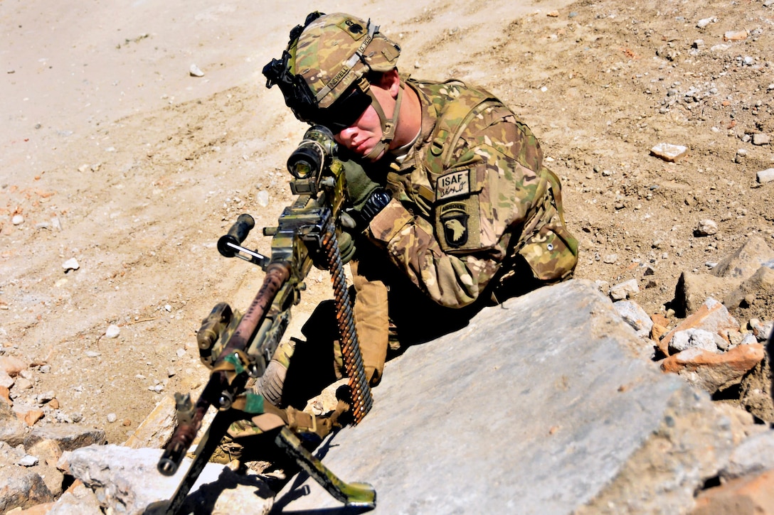 U.S. Army Spc. Christopher Newell scans the area using his machine gun's optic lens while training to maintain his tactical skills as a member of a quick reaction force on Jalalabad Airfield in Afghanistan's Nangarhar province, June 7, 2013. Newell, an M240B gunner, is assigned to the 101st Airborne Division's Company C, 1st Battalion, 327th Infantry Regiment, 1st Brigade Combat Team. As of June 18, Afghan forces have taken the lead in providing security for their country.  
