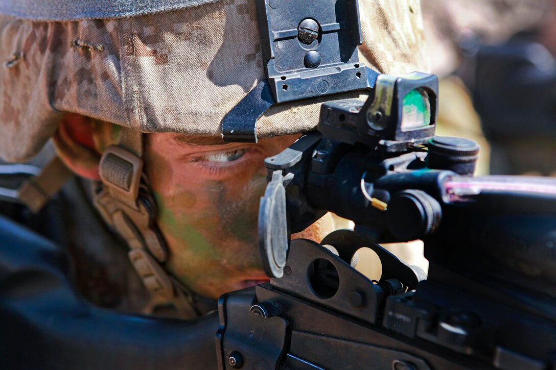 A Marine provides security from a trench during an exercise at the Mount Bundey Training Area, Australia, June 13, 2013. The Marine is assigned to Lima Company, 3rd Battalion, 3rd Marine Regiment, Marine Rotational Force Darwin. Marines from that unit and their Australian counterparts trained together in the field for two weeks.  
