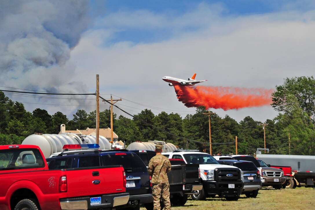 Colorado Army National Guard and Fort Carson, Colo., aviation assets provide firefighting assistance during the Black Forest fire in El Paso County, Colo., June 12, 2013. UH-60 Black Hawk and CH-47 Chinook helicopters are being used to fight the fire.  
