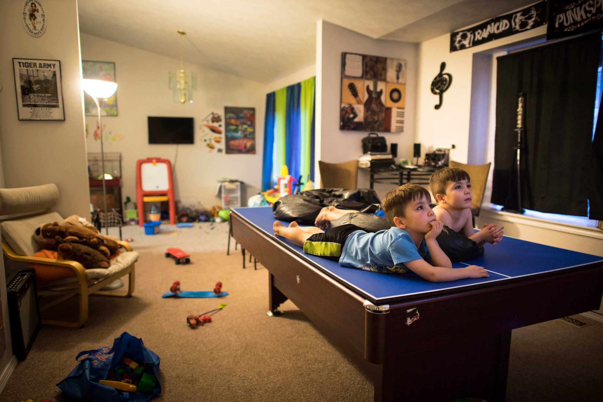 The Valley twins, Wolfgang and Jaeger, lie down while watching a TV show at their house in Mountain Home, Idaho. (U.S. Air Force photo/Tech. Sgt. Samuel Morse)