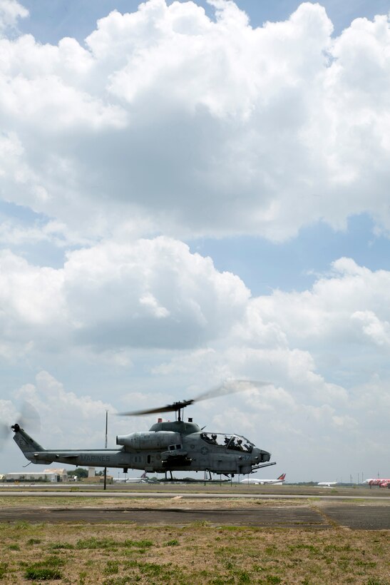 Capt. William Oren and Maj. Ferdinand Liwag prepare for takeoff during Balikatan here May 12, 2014. Senior service members of the PAF rode in the front seat of the Cobra to compare how Marines conduct flight operations versus themselves. Balikatan, in its 30th iteration, is a bilateral exercise between the U.S. and the Republic of the Philippines and aims at building both nations interoperability during joint planning, contingency, humanitarian and disaster relief operations. Oren is an AH-1W attack pilot with Marine Light Attack Helicopter Squadron 469, Marine Aircraft Group 12, 1st Marine Aircraft Wing under the Unit Deployment Program. Liwag is a McDonnell Douglas 520 Military Gunship pilot with the 18th Attack Squadron, 15th Strike Wing. The Super Cobra is with HMLA-469, MAG-12, 1st MAW.