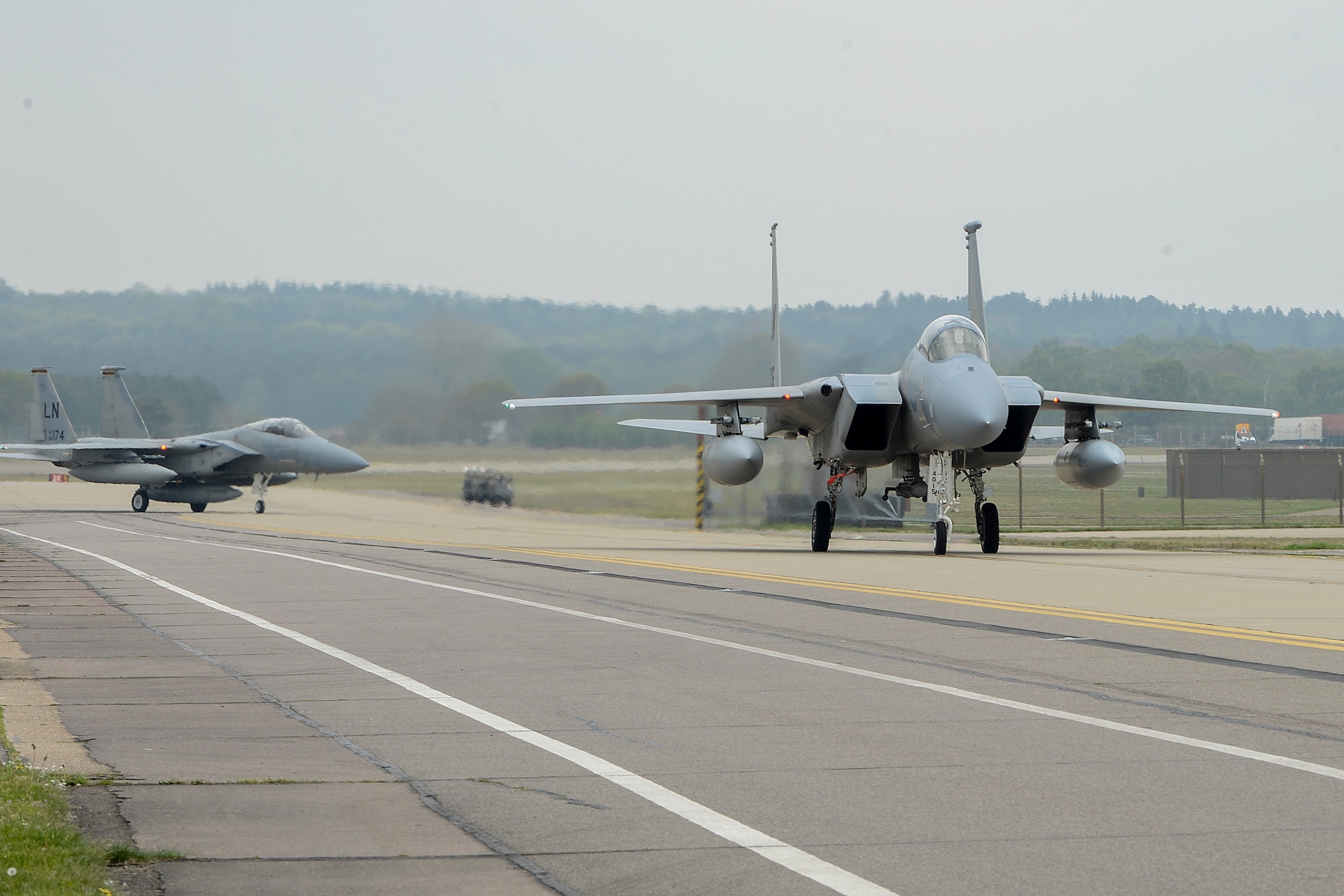 Two F-15C Eagles taxi down the flightline after returning from the 48th Fighter Wing’s participation in Baltic Air Policing May 1, 2014, at Royal Air Force Lakenheath, England. The U.S. Air Force’s 48th Air Expeditionary Group handed over the reins of NATO’s BAP mission to the air forces of Poland and the United Kingdom during a ceremony at Šiauliai Air Base, Lithuania, April 30, 2014. (U.S. Air Force photo/Airman 1st Class Trevor T. McBride)
 