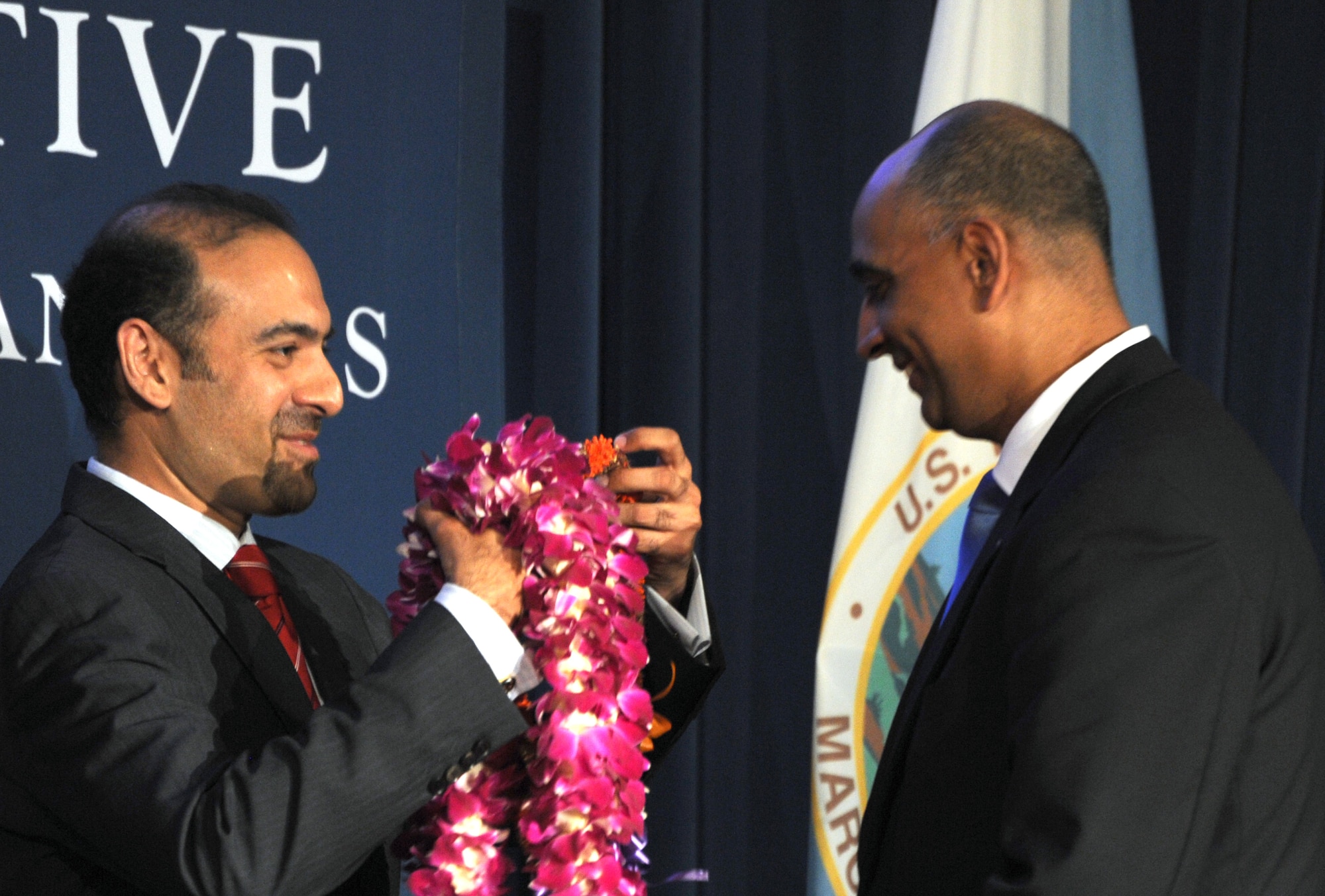 A President's Advisory Commission member presents a lei to Lt. Col. Ravi Chaudhary May 6, 2014, during the Asian American and Pacific Islanders Heritage Month Opening Ceremony in Washington, D.C. During the ceremony, Chaudhary was sworn in as a member of the President's Advisory Commission on AAPIs. As a commission member, Chaudhary is charged with working to improve the quality of life for AAPIs through increased participation in and access to federal programs. Chaudhary is an Air Force District of Washington executive officer. (U.S. Air Force photo/Master Sgt. Tammie Moore) 
 
