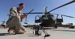 Army 1st Lt. Amanda Birch, a UH-60 Black Hawk pilot with the Arizona Army National Guard’s 2/285th Air Assault Helicopter Battalion, Alpha Company, prepares for a night mission during Operation Angel Thunder 2014 at Papago Military Reservation in Phoenix, May 12, 2014.