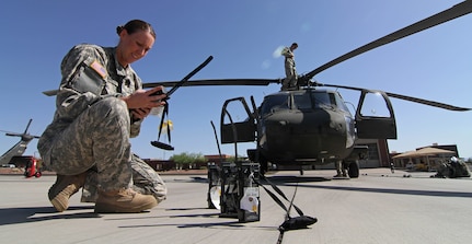 Army 1st Lt. Amanda Birch, a UH-60 Black Hawk pilot with the Arizona Army National Guard’s 2/285th Air Assault Helicopter Battalion, Alpha Company, prepares for a night mission during Operation Angel Thunder 2014 at Papago Military Reservation in Phoenix, May 12, 2014.