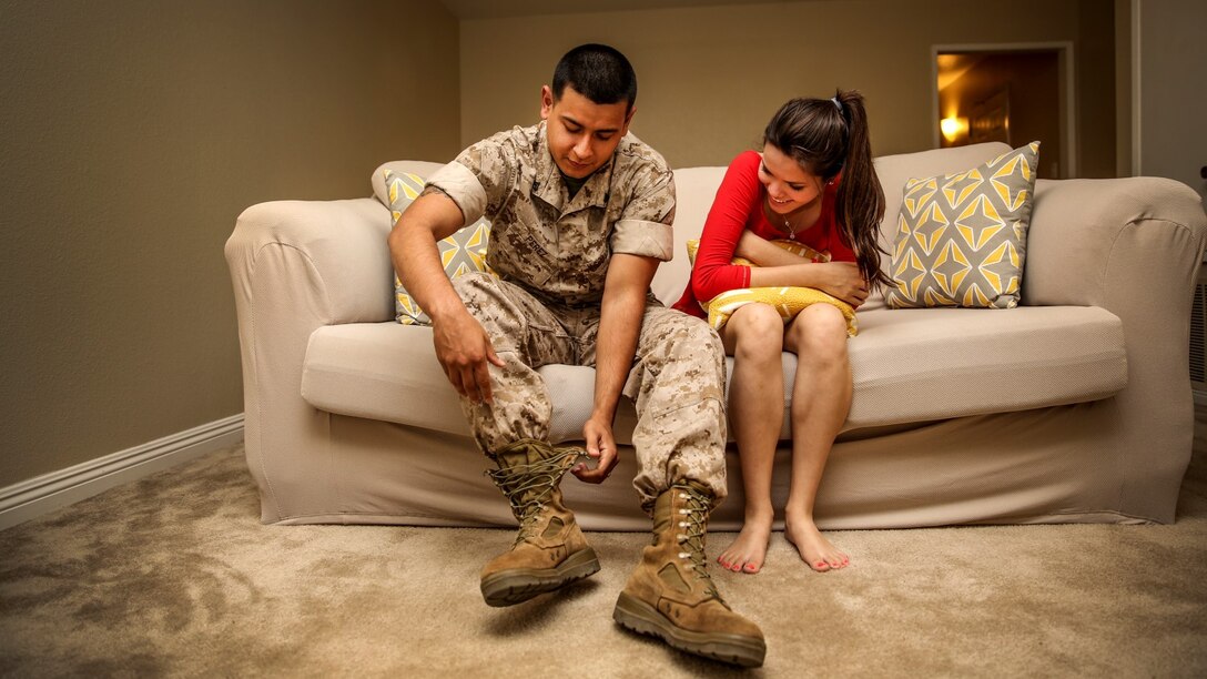 Corporal Alberto Perez III, left, administrative specialist, 15th Marine Expeditionary Unit, sits next to his wife, Carla Jimenez, as he takes his boots off after work aboard Camp Pendleton, Calif., May 8, 2014. Perez, 22, is from Burbank, Calif. (U.S. Marine Corps photo by Cpl. Emmanuel Ramos/Released)